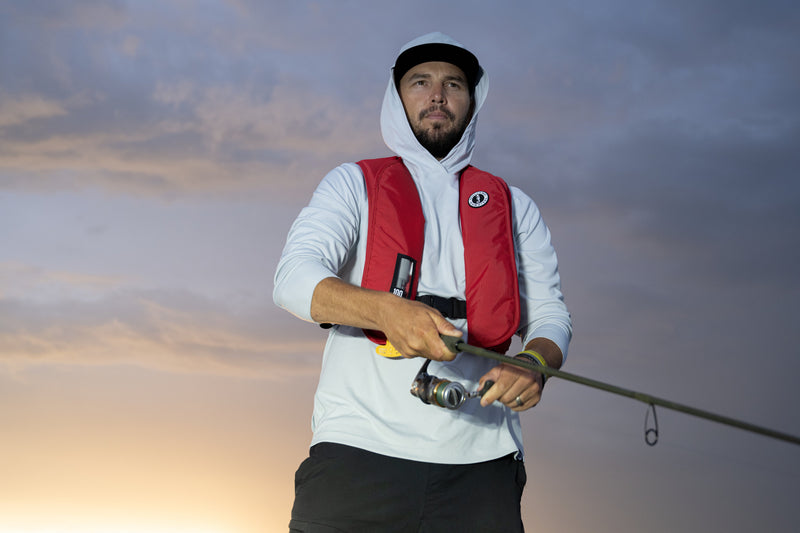 Angler wearing an inflatable PFD in a warm climate showing inflatables are a great option if you want a low profile safety option