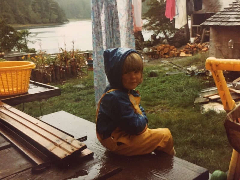 Copywriter, Danielle Baker, as a child, on her front porch on a cool rainy day at her home in Bamfield, BC