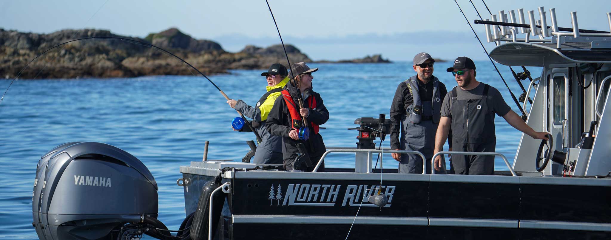 Anglers having fun on a boat wearing life jackets and PFDs